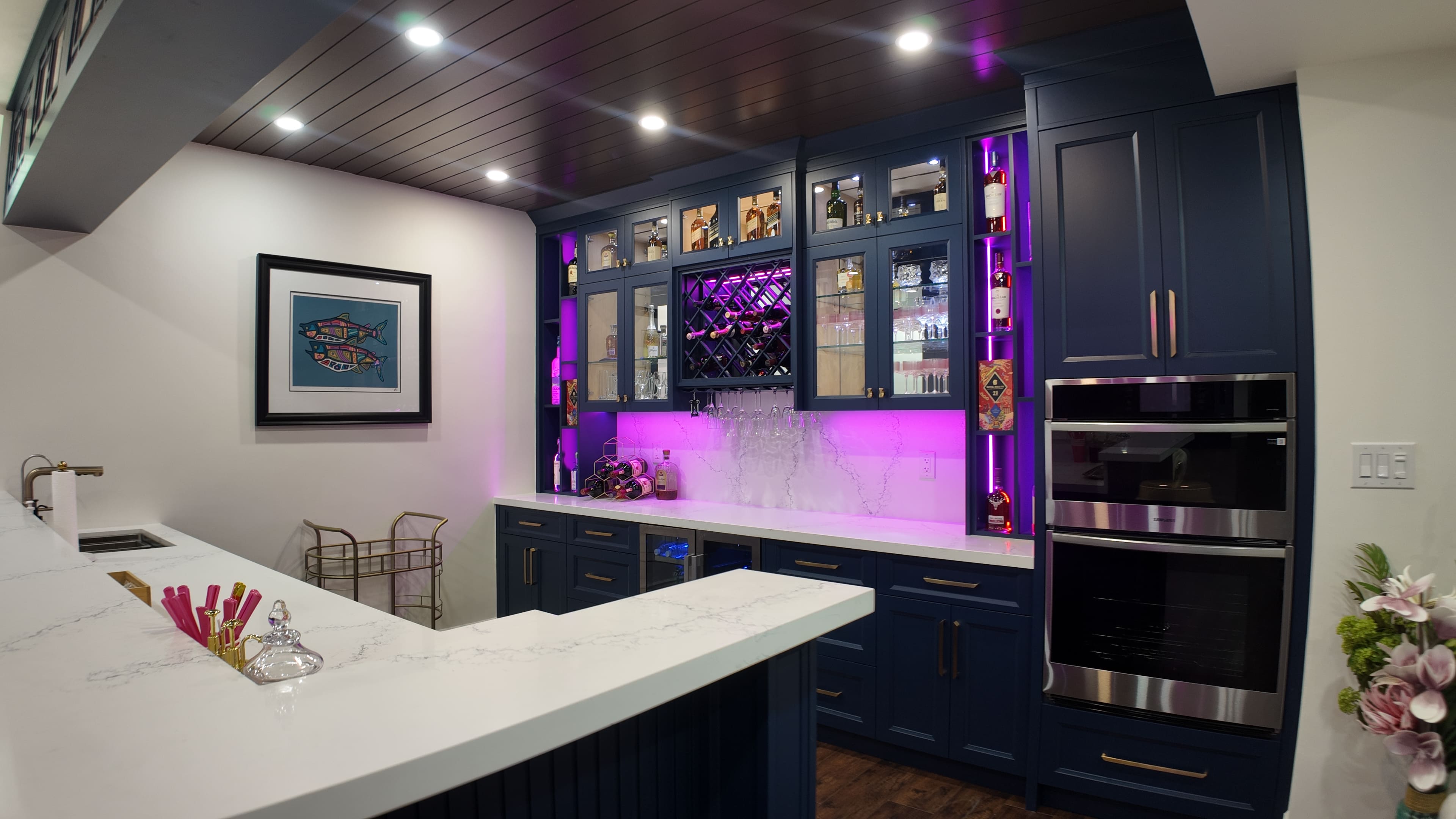 Finished basement wet bar with custom cabinetry and premium finishes