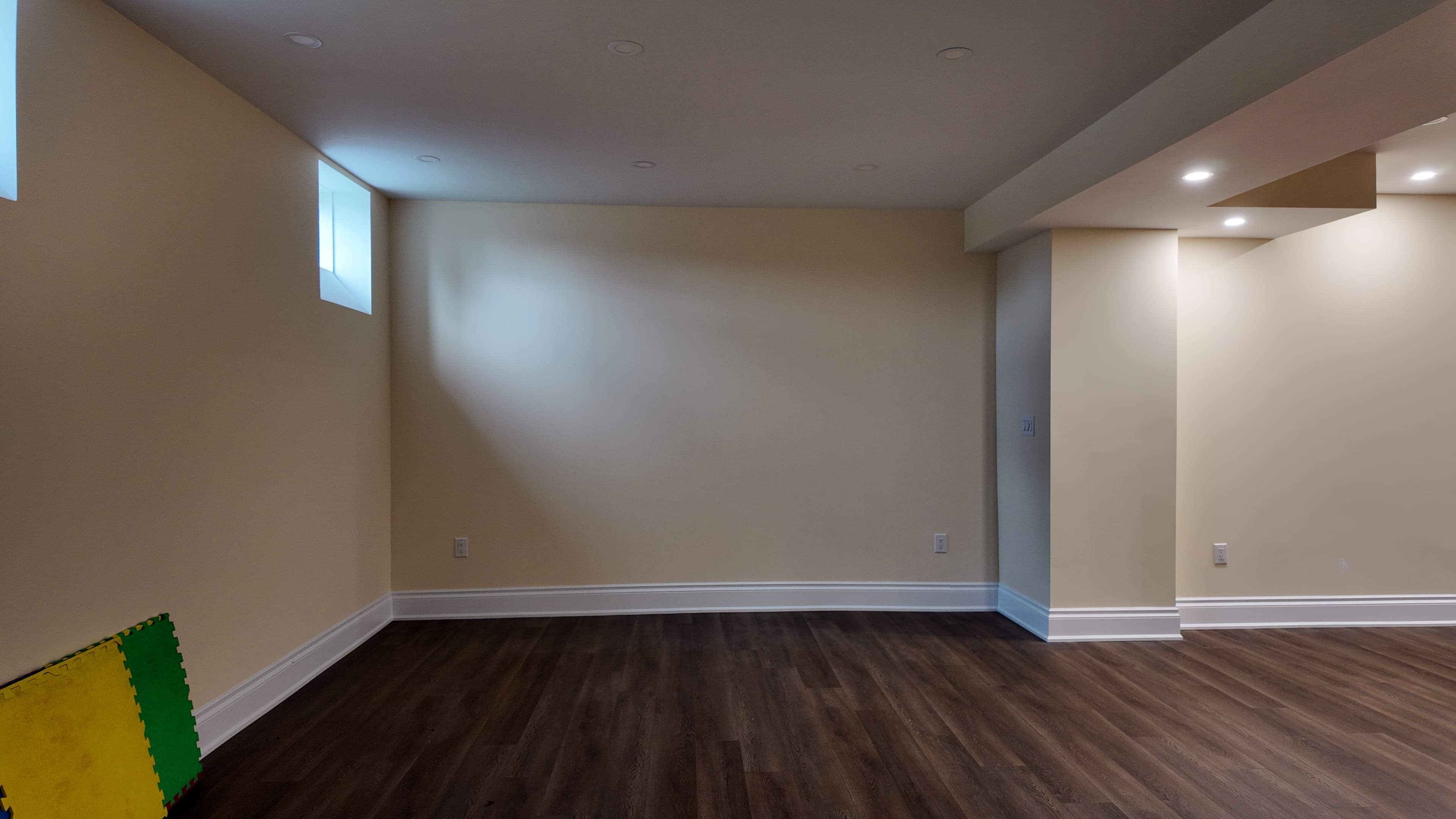 Unfinished basement living area before renovation